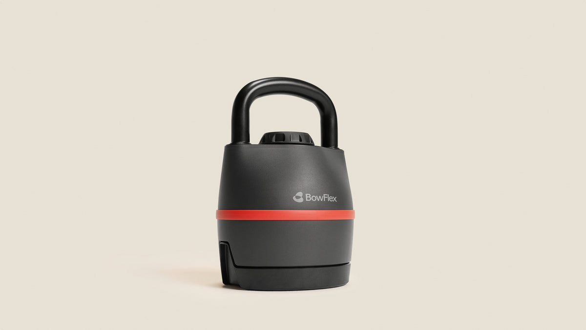 Angled front view of the BowFlex SelectTech 840 Kettlebell against a tan background.