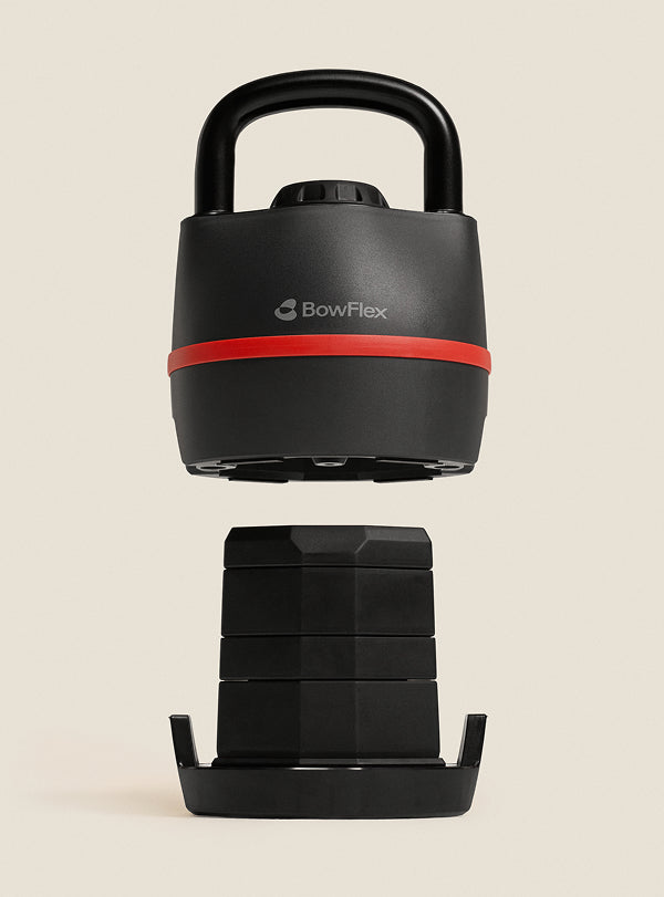 The BowFlex SelectTech 840 Kettlebell lifted above its weight plates.