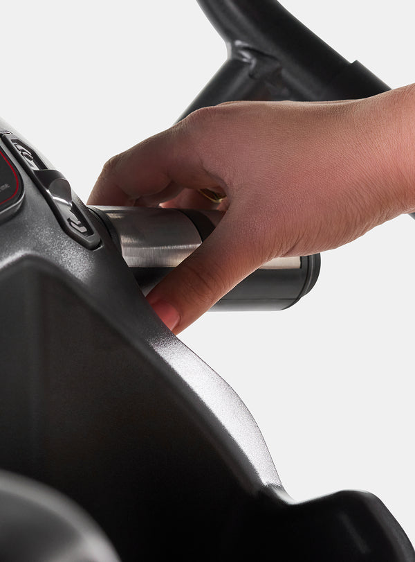 A hand on a BowFlex Max Trainer M6 heart rate hand grip.