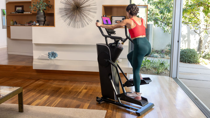 Person exercising on the BowFlex Max Trainer SEi in a home setting.