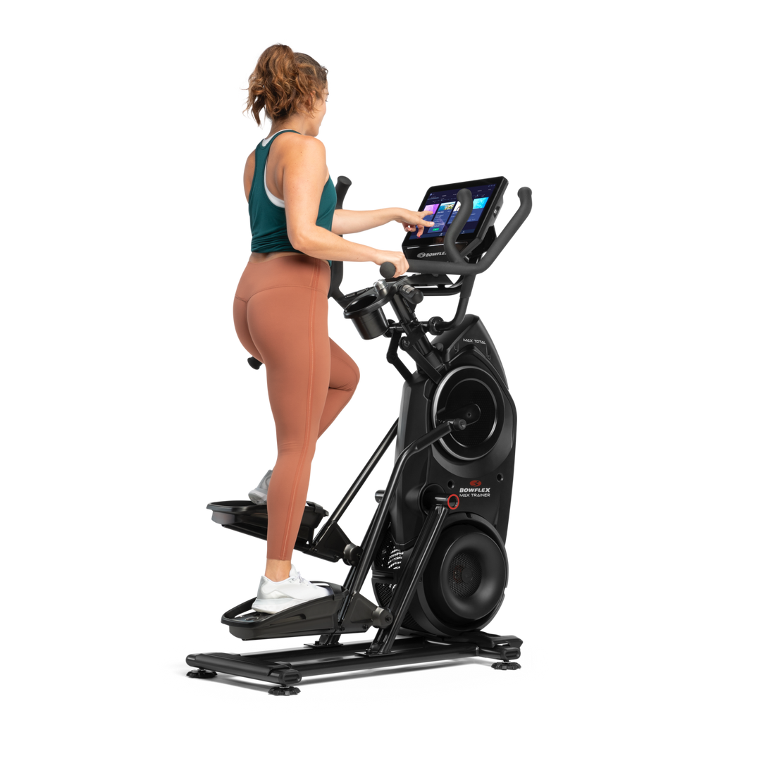 A woman exercising on a BowFlex Max Total 40.