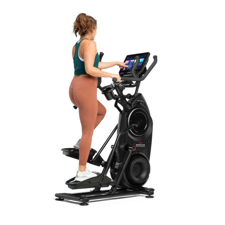 A woman exercising on a BowFlex Max Total 40.