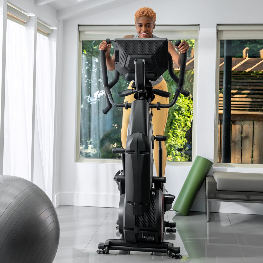 A woman working out on a BowFlex Max Total 40.