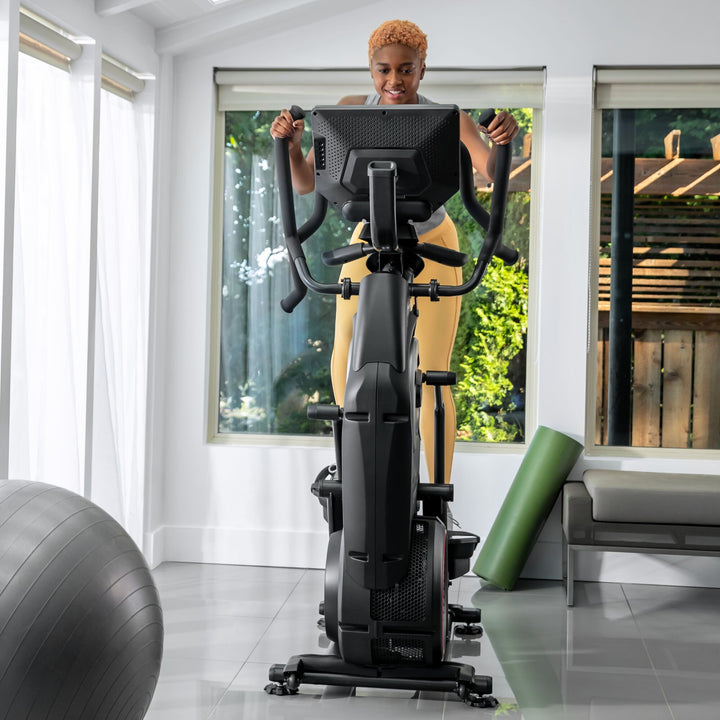 A woman working out on a BowFlex Max Total 40.