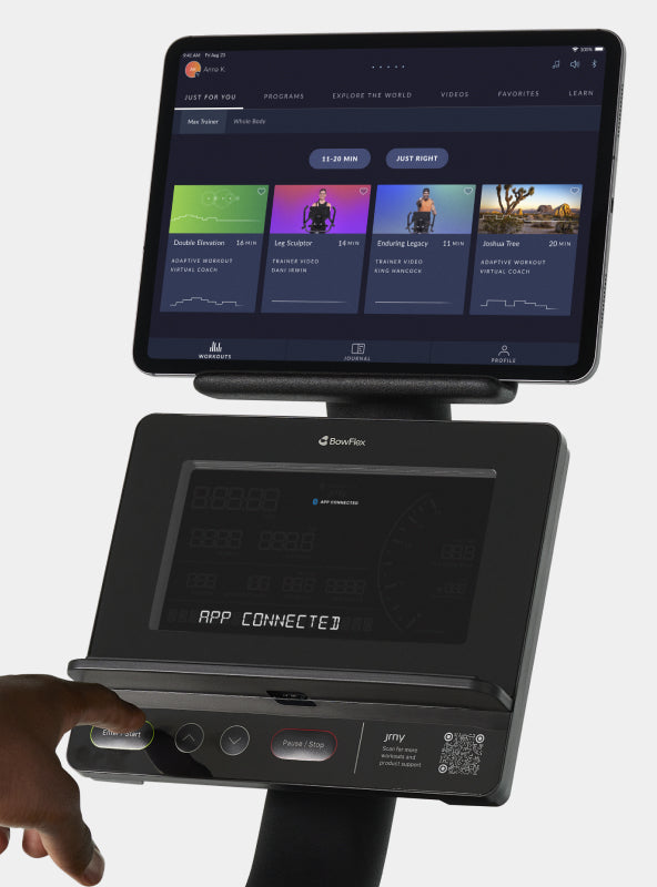 A tablet with JRNY app screen displayed on the BowFlex Max Trainer SEi media shelf.