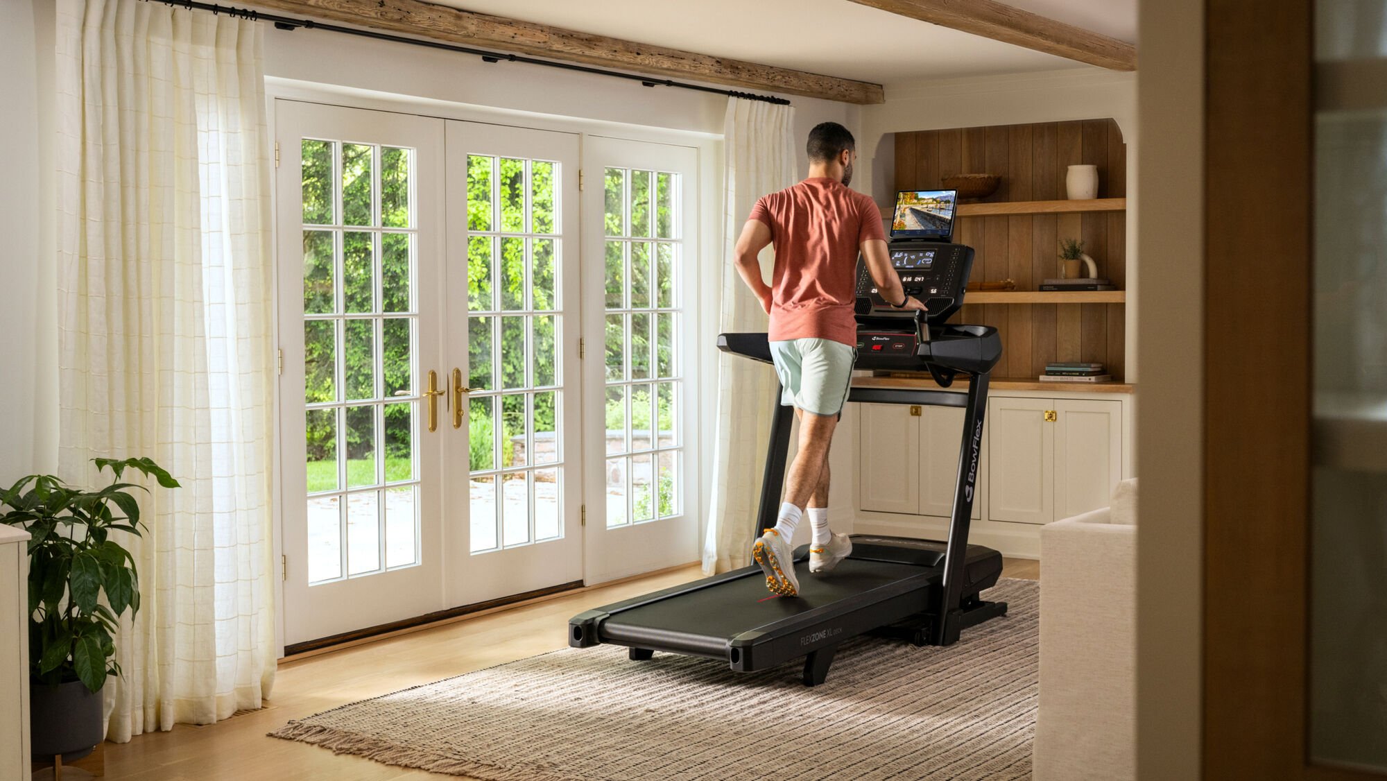 Man running on the T9 Treadmill in home - default view
