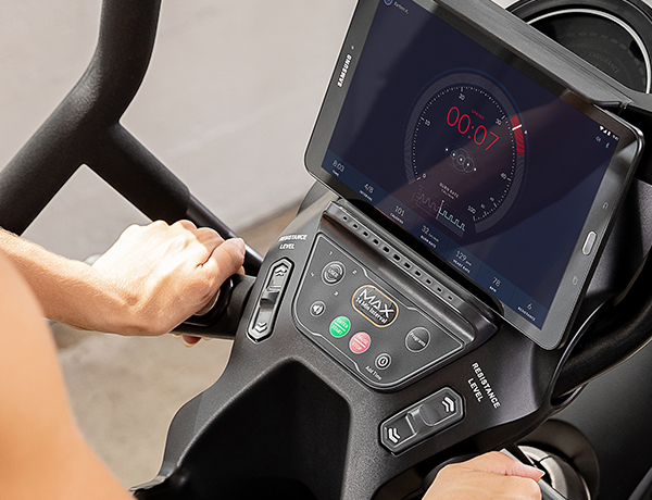 Max console coaches a woman through a workout