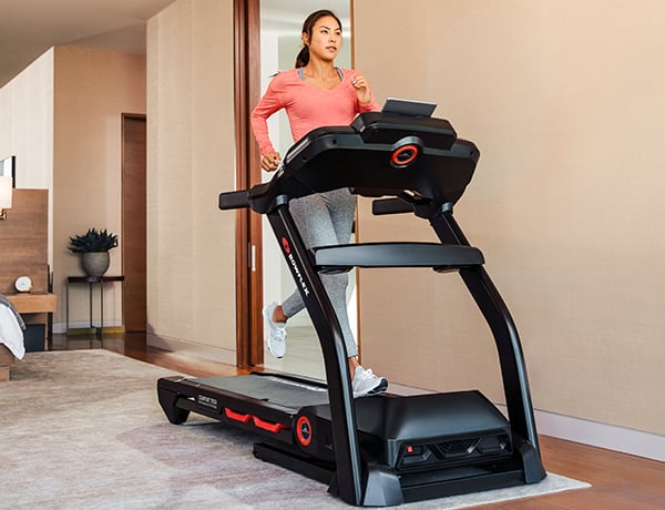 man running on a BXT216 Treadmill in a sunny room